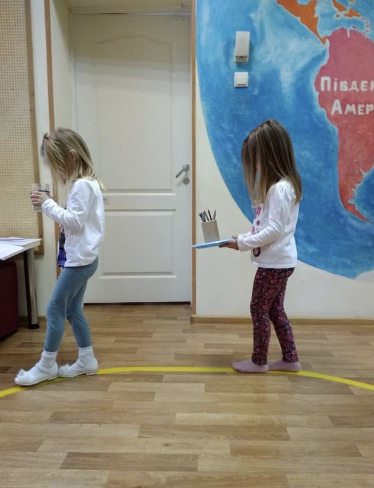 Montessori walking on the line activity with a child practicing balance and coordination without touching classroom objects