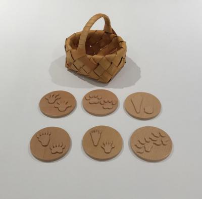Set of 6 wooden animal track stamps with woven basket