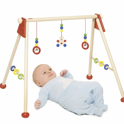 Montessori baby gym with red rings and colorful wooden beads for sensory development