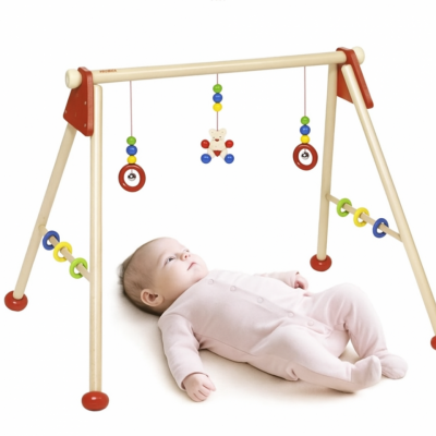 Montessori baby gym with red rings and colorful wooden beads for sensory development