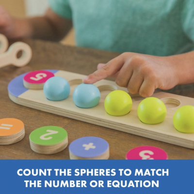 Early math activity with wooden number and symbol tokens for addition and subtraction