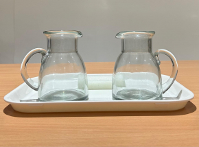 Montessori pouring activity with two clear glass pitchers for practical life